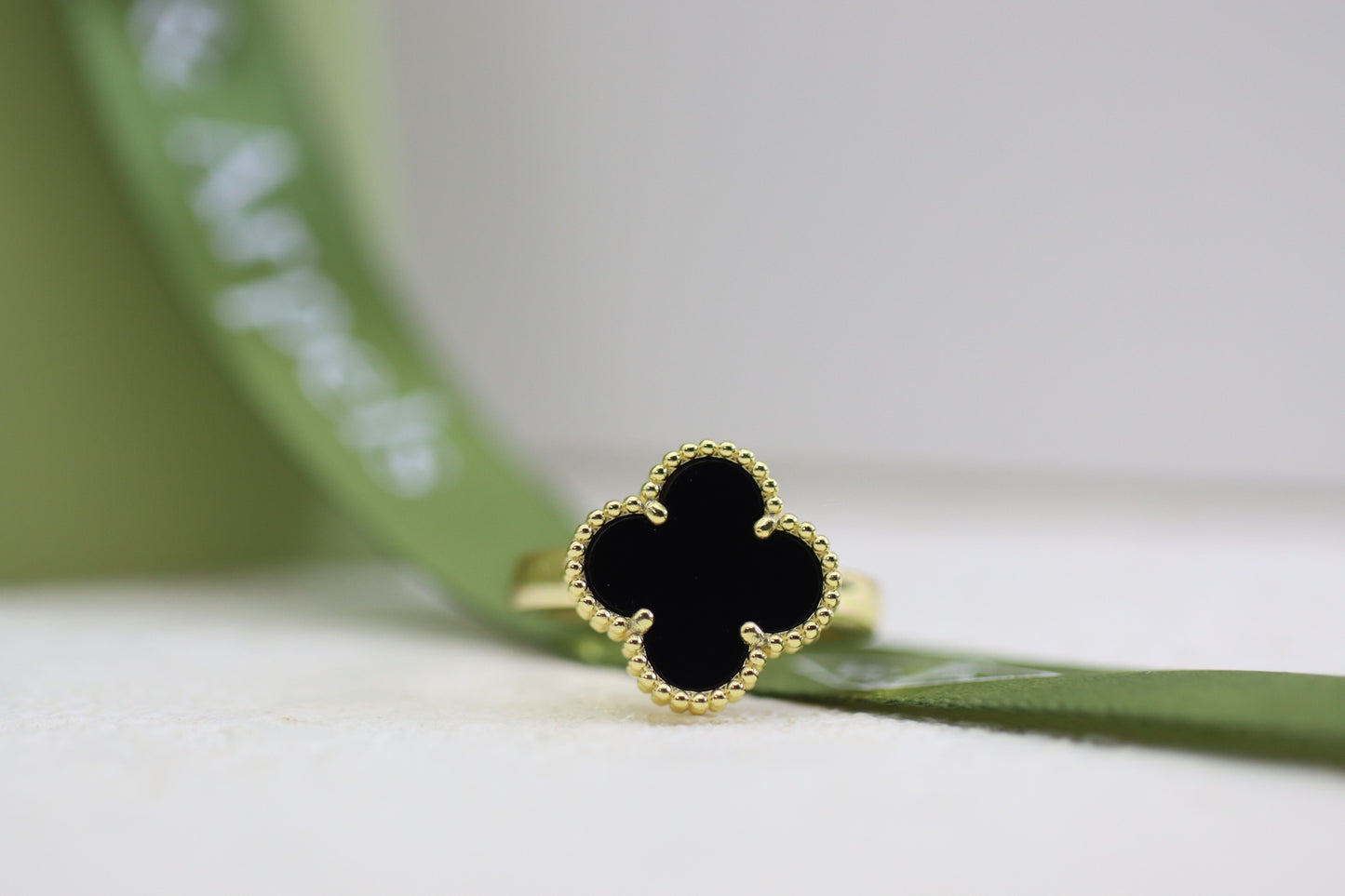 Champagne gold and black onyx four-leaf clover ring
